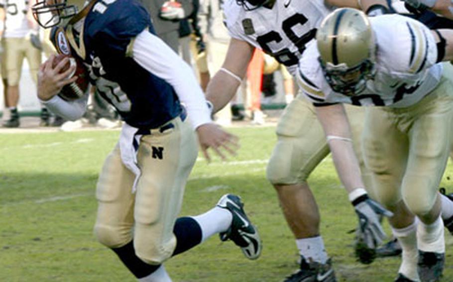 Navy quarterback Kaipo-Noa Kaheaku-Enhada breaks away from Army defenders Tony Fusco (66) and Cameron Craig during the 2006 Army-Navy game. Kaheaku-Enhada has rushed for 755 yards and completed 46 of 79 passes for 823 yards in 2007.