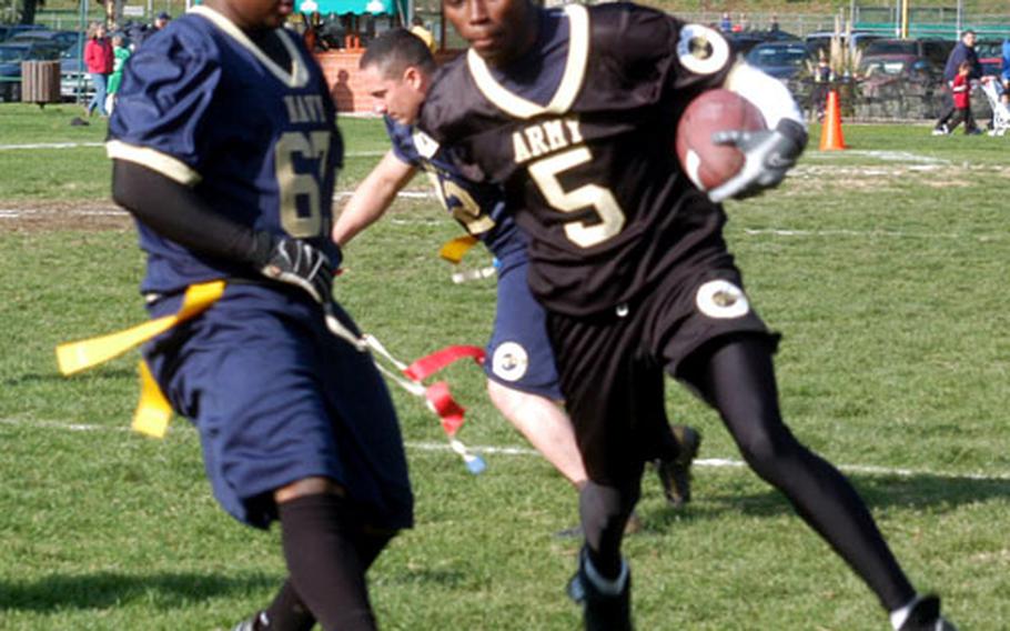 Navy defender Cedrick Victor grabs the flag off Army’s Terrence Parker, during the annual Army-Navy flag football game played at Carney Park in Naples. Navy won 20-8.