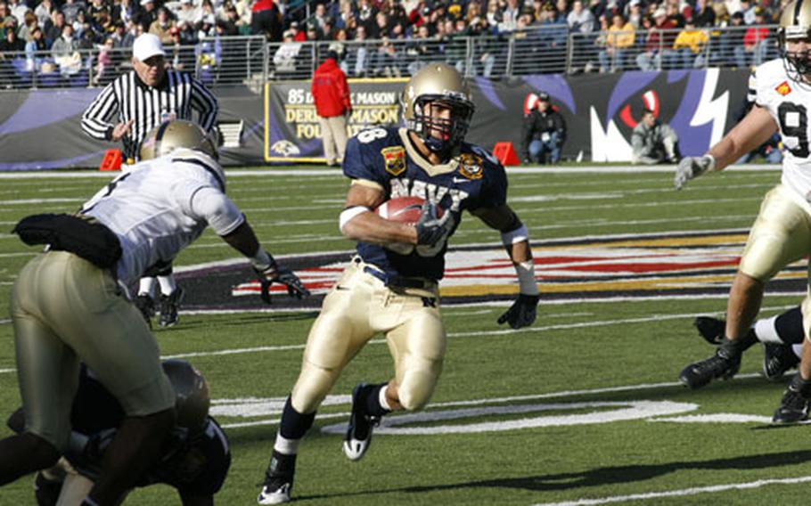 Navy Slotback Zerbin Singleton jukes by Army defenders during his first-quarter 38-yard touchdown run to kick off the Navy route.