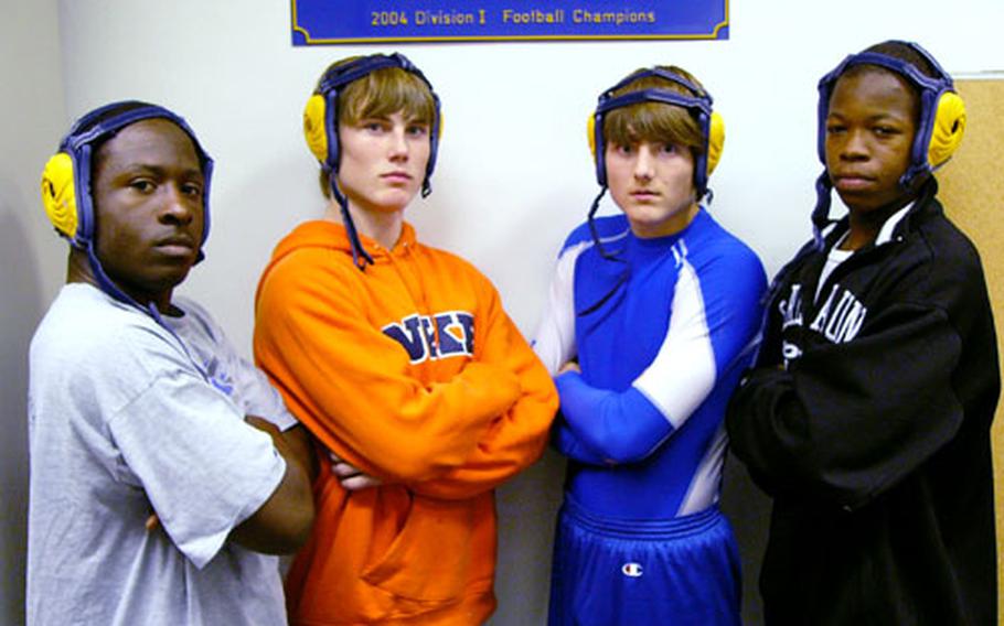 Three returning DODDS-European medalists -- Ronald Peebles, left, Chris Spencer, second from right, and Tahji Peebles, right -- along with freshman Michael Spencer, put on their game faces as they get ready to start their game faces in preparation for the 2007-2008 high school wrestling season, which opens Saturday at five sites across Europe.