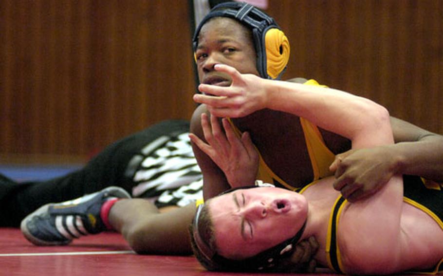Taji Peebles of Weisbaden attempts to pin Aubry Blad of Hanau during the second period of the 125 pound finals Saturday at the Kaiserslautern High School gym. Peebles beat Blad 11-7.