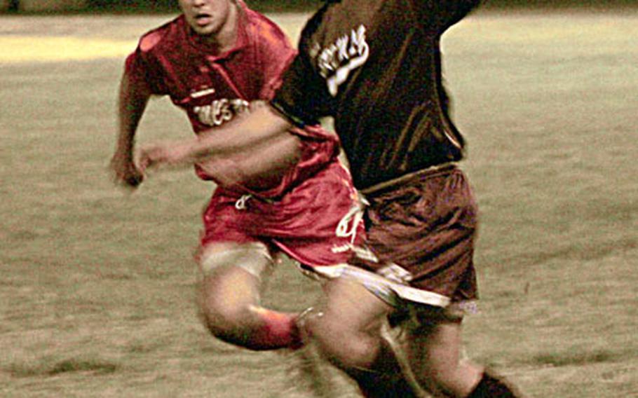 3rd Marine Logistics Group&#39;s Manuel Aponte-Blanco, right, races against a Marine Corps Base Camp Butler player for control of the ball during the championship match of the 2007 Marine Corps Far East Regional Soccer Tournament Thursday night on Camp Courtney. 3rd Marine Logistics Group won, 5-1.