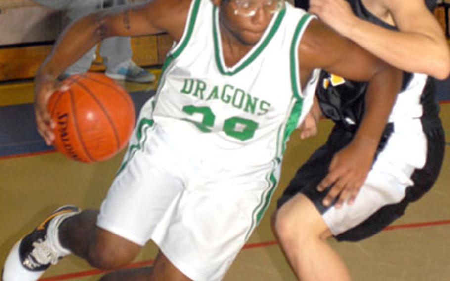 Kubasaki Dragons senior Rodney Brown (20) dribbles around Kadena Panthers senior Patrick McDermott during Friday's pool-play game in the 2nd New Years Classic high school boys basketball tournament at Capps Gym, Yokota High School, Yokota Air Base, Japan. Kubasaki won 72-34.