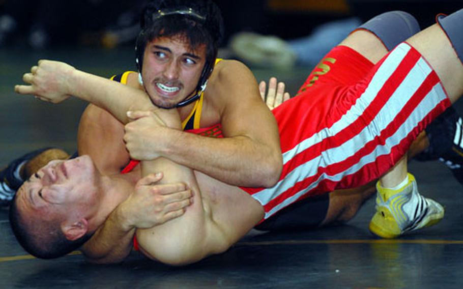 Kadena’s Jacob Bloom does a front chest press on Ryuta Kimura of Shonan Military High School during Saturday’s championship meet in the Nile C. Kinnick Invitational “Beast of the Far East” Wrestling Tournament at Yokosuka Middle School, Yokosuka Naval Base, Japan. Bloom won the 158-pound bout by pinning Kimura in 1 minute, 6 seconds. Kadena defeated Shonan 35-27 to win the title in the dual-meet event.