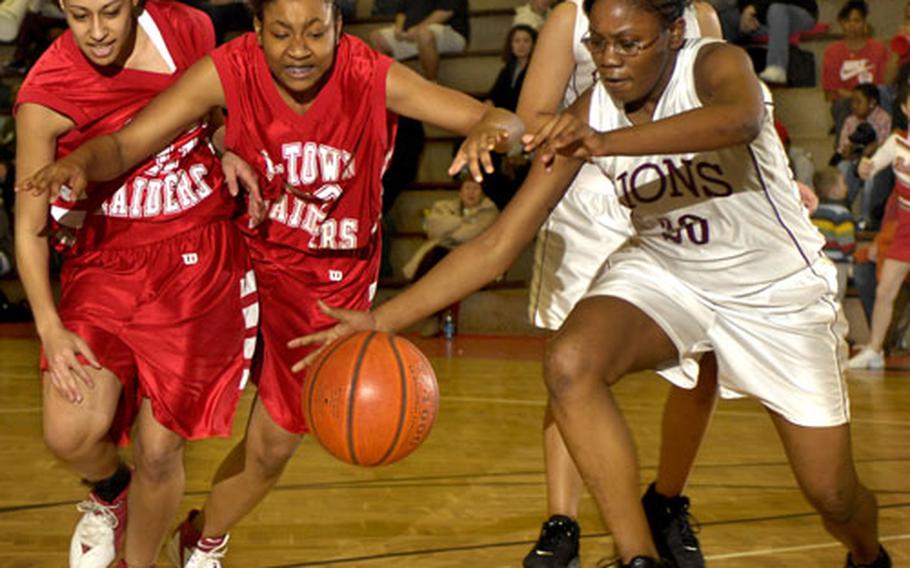 Shalisa Baldwin and Keiana Allen of Kaiserslautern clash with Kierra Tdoiere of AFNORTH during the first half of play Saturday in Kaiserslautern. Kaiserslautern defeated AFNORTH, 47-18.