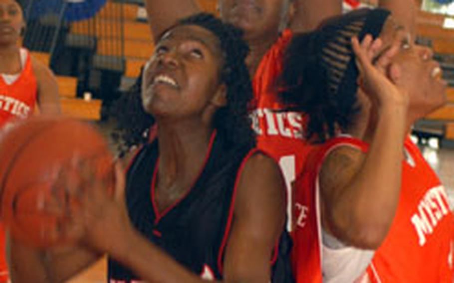 Camp Red Cloud’s Shavonne Holden tries to shoot against Mystics April Moss, rear, and Amoni Suttice in the women's championship game at the 14th Martin Luther King Invitational Basketball Tournament. Camp Red Cloud beat Mystics 68-51.