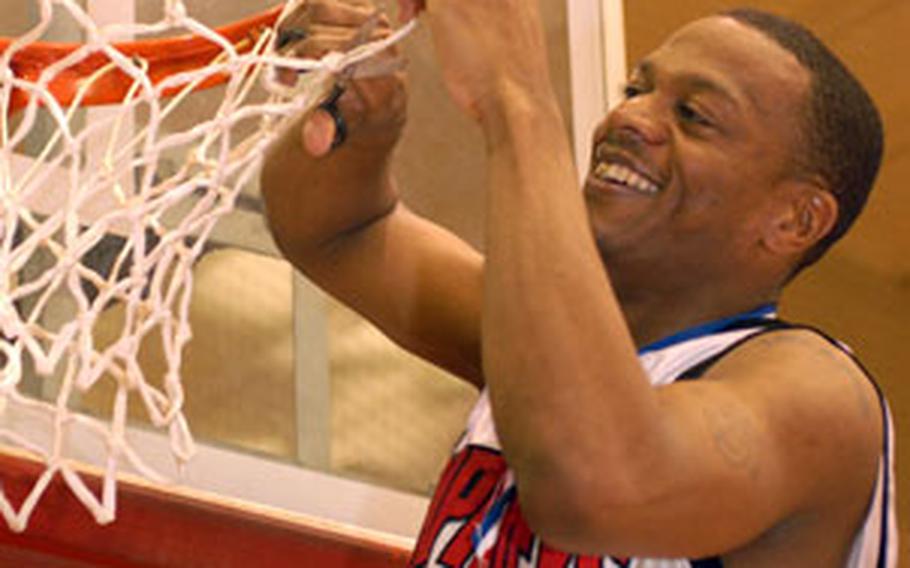 Camp Humphreys’ Lorenzo Thompson cuts down the net.