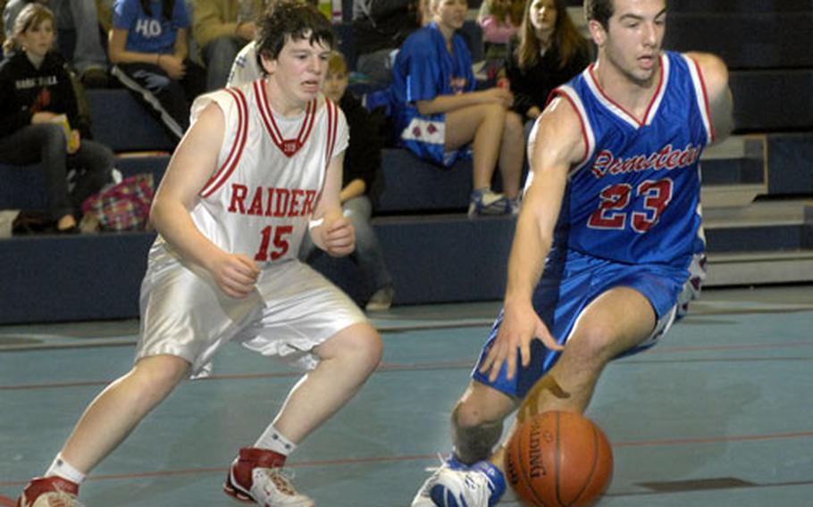 Ramstein junior Evan Canfield drives past Isaac Skelton of ISB on Saturday at Ramstein.