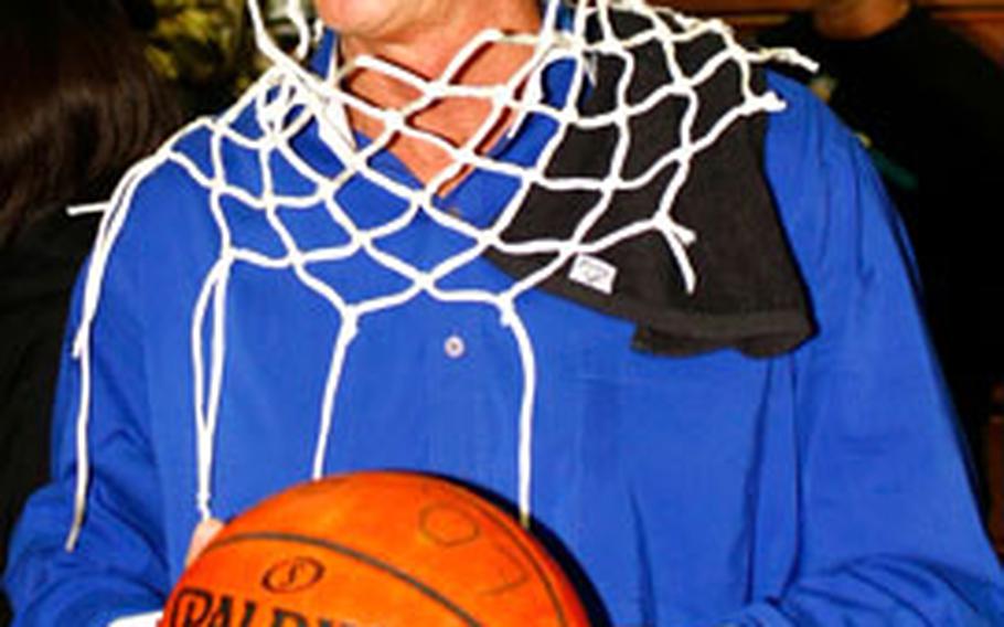 Seoul American coach Steve Boyd wears the net cords around his neck after Saturday’s championship game in the Boys Class AA tournament at Seoul American High School, South Post, Yongsan Garrison, South Korea. The Falcons beat Kadena 64-60 for their third title in six years.