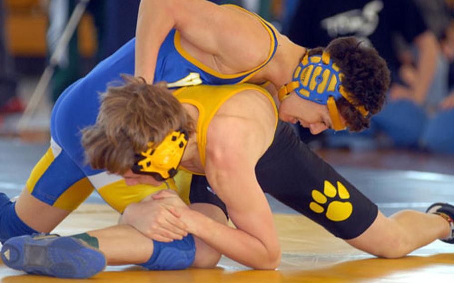 Seth Ennis of Kadena, bottom, grabs a hold of Mark Meade of Yokota during last month’s Far East tournament. The double-elimination format was controversial, but FEAC chair Don Hobbs said it would continue.