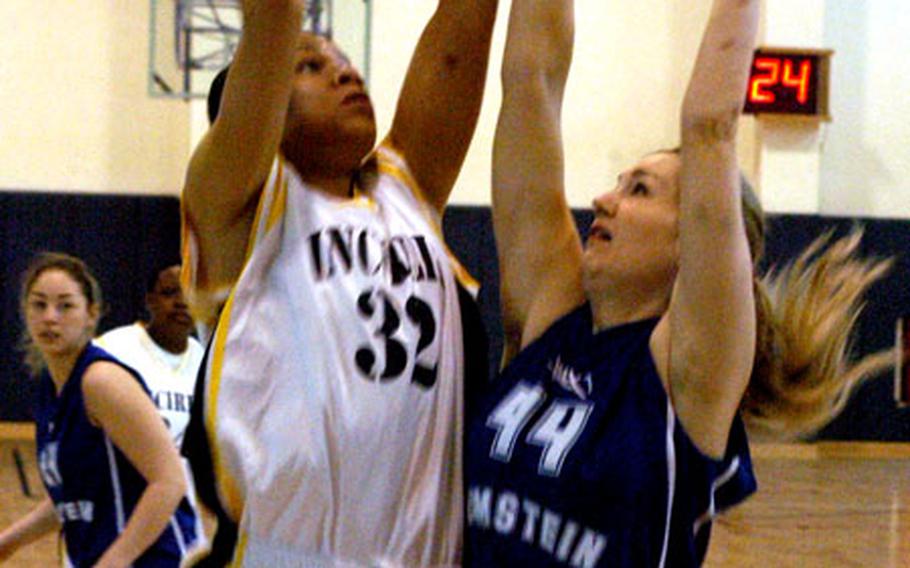 Incirlik’s Rukiya Durden puts up a shot while defended by Ramstein’s Brooke Bozarth during the finals of the USAFE Basketball Championships. Incirlik came from behind to topple the Lady Rams 45-43.