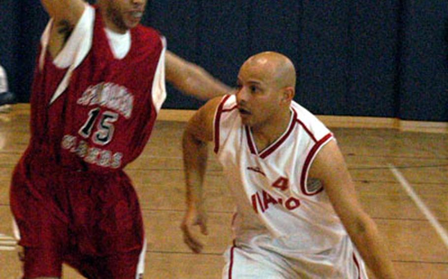 Aviano’s Chris Moed tries to drive past Spangdahlem’s Cory Stallworth during the finals of the USAFE Basketball Championships on Saturday. Aviano won the game, 78-72, to secure its second straight title.