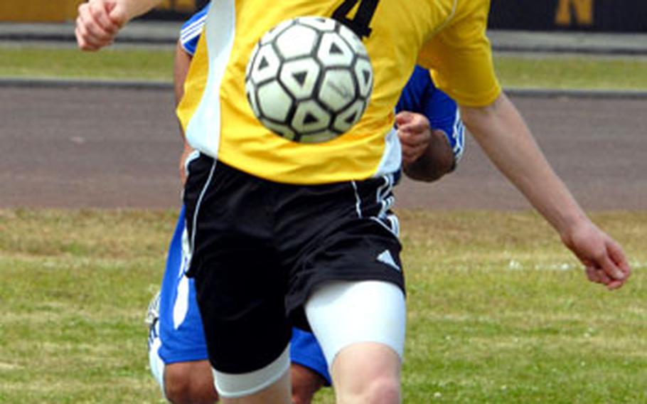 Kadena sophomore center-forward Stan Schrock dribbles the ball against Mil United during Saturday&#39;s game. Mil United blanked Kadena 4-0, after beating Kubasaki 3-1 on Friday.