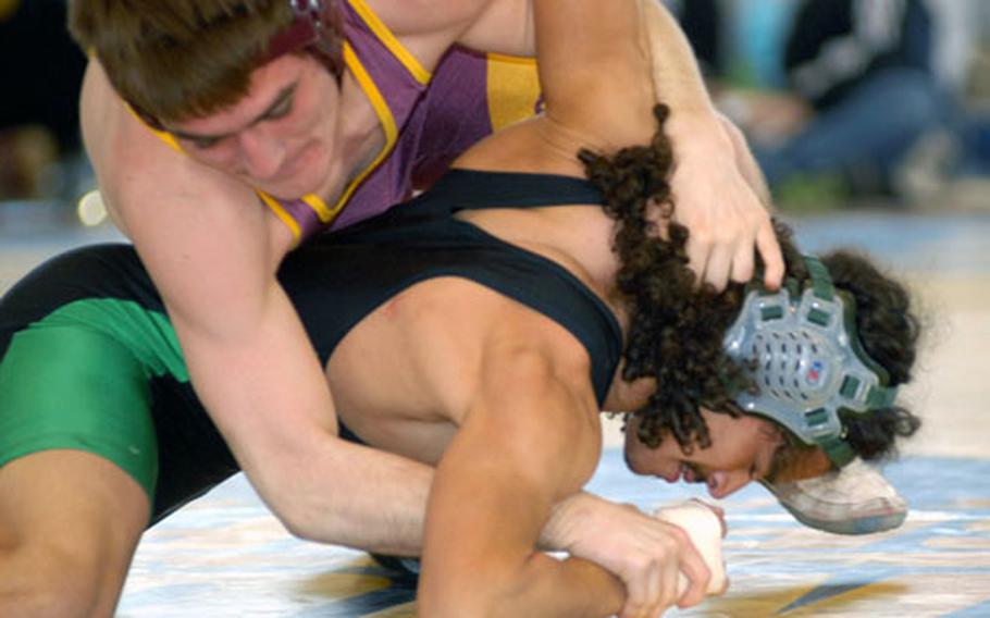 Craig Bell, top, tries to turn the shoulders of Kubasaki’s Josh Bales toward the mat during the 122-pound final in the Far East wrestling tournament. Bell beat Bales by decision. Bell, the lone wrestler representing Matthew C. Perry High School in Japan, has been chosen as Stars and Stripes male Athlete of the Quarter.