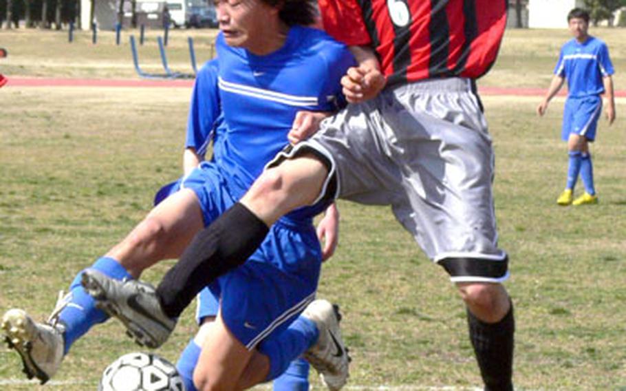 Kenta Takahashi, left, of Yokota and Nozomi de Lencquesaing (6) of St. Maur International battle for the ball during Saturday&#39;s game. Yokota rallied to beat St. Maur 3-2.