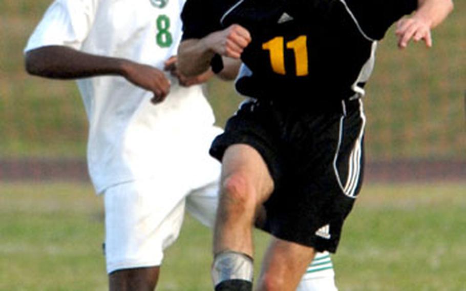 Will Mackey of Kadena heads the ball in front of Rimar West of Kubasaki.