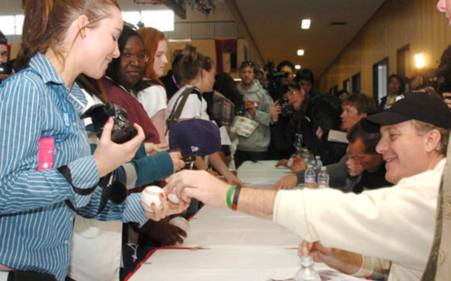 Boston Red Sox pitcher Curt Schilling signs an autograph for Mariah Sheehan, a junior at Zama American High School, during his visit to Camp Zama, Japan, on Friday.