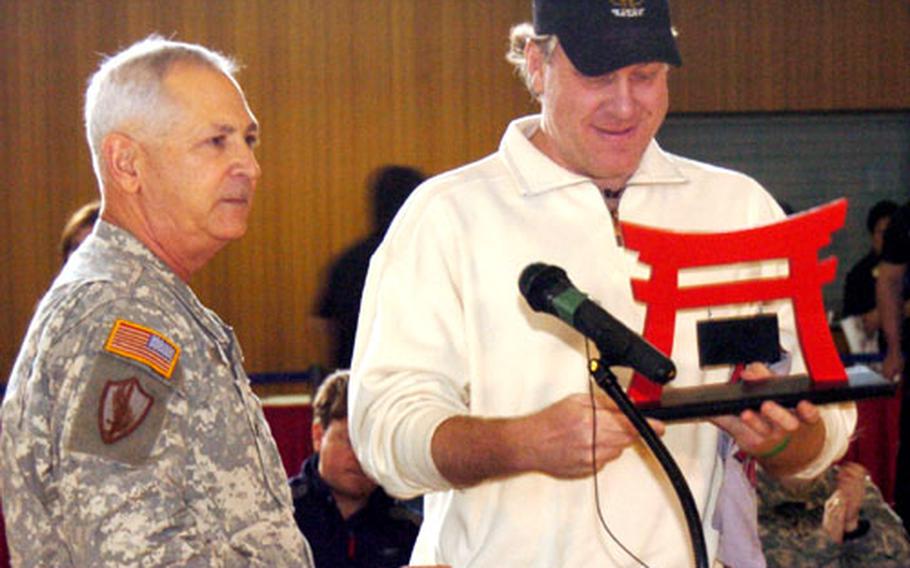 Boston Red Sox pitcher Curt Schilling receives a gift from Maj. Gen. Elbert N. Perkins on Friday at Camp Zama.