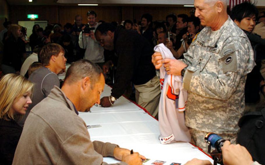 Maj. Gen. Elbert N. Perkins is given a jersey signed by Tim Wakefield, foreground.