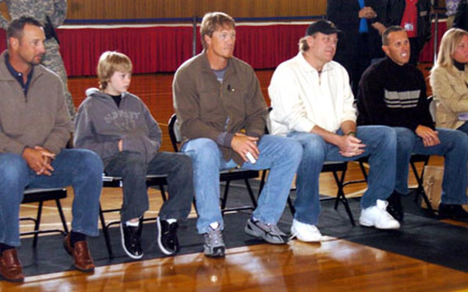 Boston Red Sox pitchers Tim Wakefield, Mike Timlin, Curt Schilling and Bryan Corey sit with members of their families before signing autographs for servicemembers at Camp Zama.