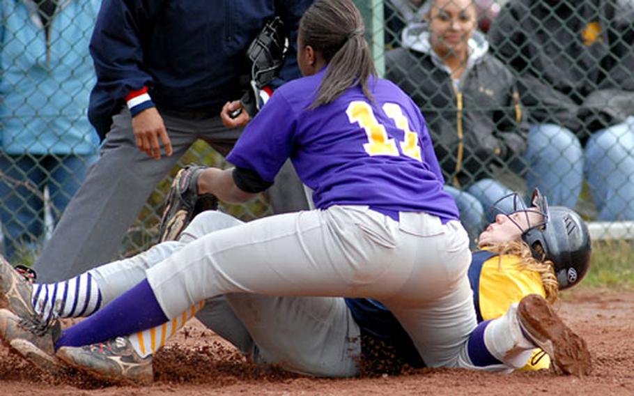 Heidelberg&#39;s Kelsey Little slides under the tag of Mannheim pitcher Erica Wilson in the second game of a doubleheader. Heidelberg won both games, 17-0 and 17-7, on the opening weekend of the DODDS-Europe spring sports season.
