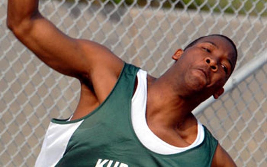 Kubasaki&#39;s Lawrence McClain throws the shot put during Friday&#39;s meet . McClain won the event with a put of 12.22 metres.