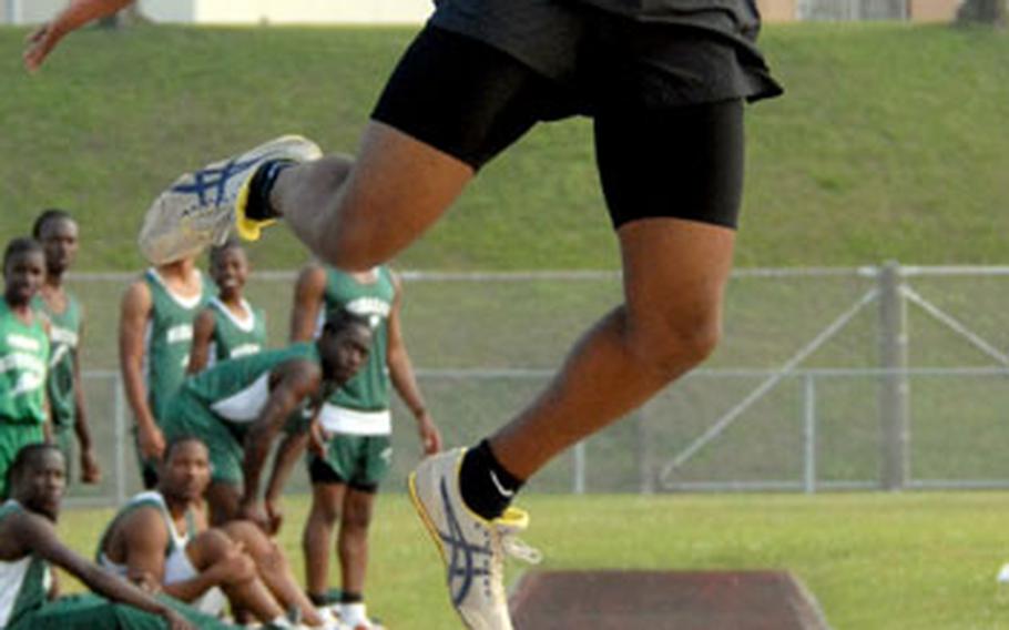 Kadena senior Ernest Carr long jumps during Friday&#39;s meet. Carr won the event in 19 feet, 3 inches on his first leap.