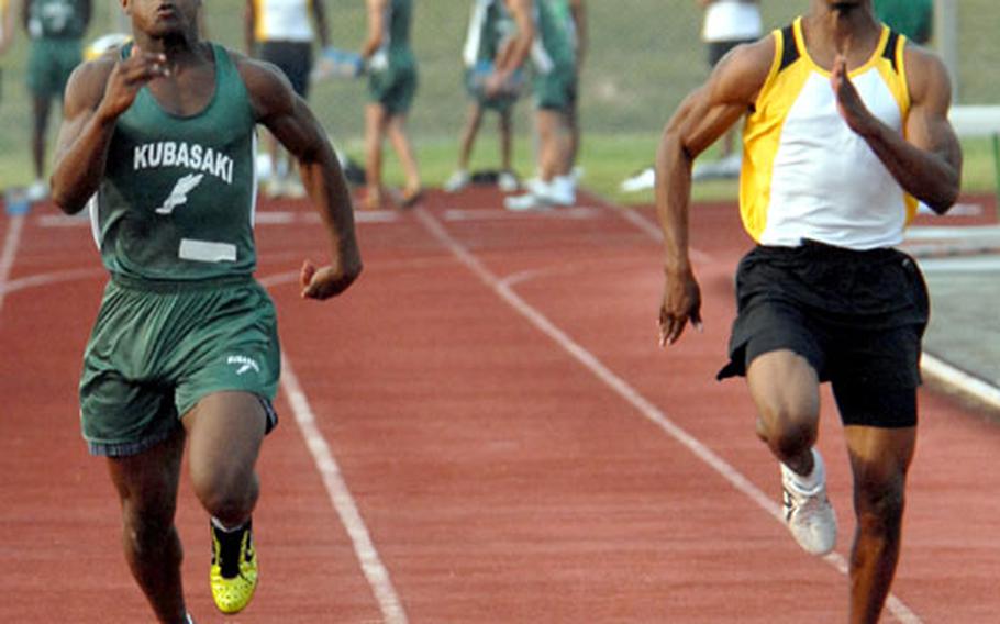 Kubasaki&#39;s Marquette Warren, left, and Kadena&#39;s Shun Bowens sprint to the finish line in Heat 1 of the 100-meter dash. Bowens won the event in 11.15 seconds; Warren was third in 11.45.