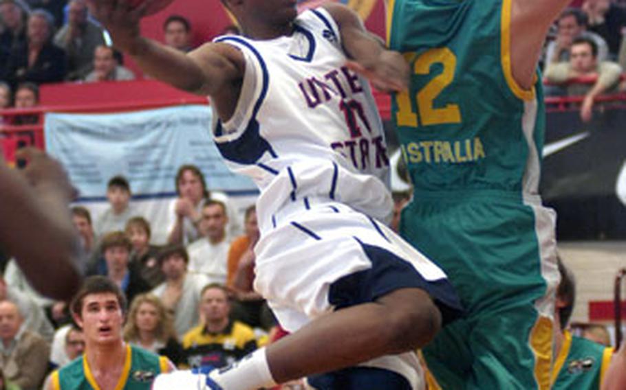 Team USA&#39;s Wally Judge of Jacksonville, Fla., soars to the hoop around Jordan Vandenberg of Australia during the first half of the Albert Schweitzer Tournament&#39;s bronze-medal game on Saturday at the Mannheim Sports Arena. The U.S. lost to Australia, 87-67.