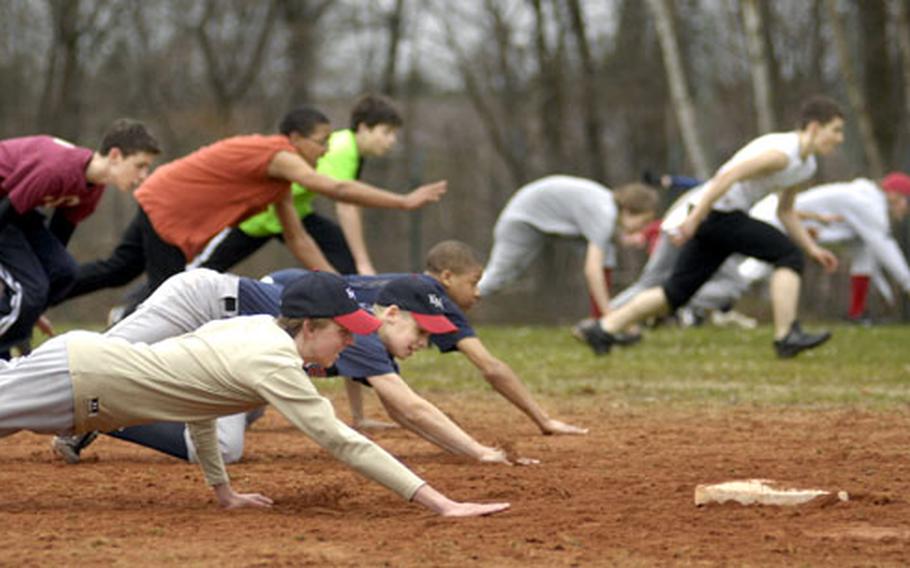 Shaun Kemp, front, a freshman at Kaiserslautern High School, slides with the rest of his “Vogelweh 1” baseball team during a base-stealing exercise at a practice Wednesday at Ramstein, Germany. Because DODDS doesn’t offer baseball as an official sport in Europe, the Morale Welfare and Recreation’s Child and Youth Services runs what passes for the high school baseball program.
