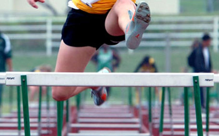 Kadena sophomore hurdler Shannon Steele runs the 100 hurdles. Competing in separate heats, Steele edged teammate Alisha Juko, 18.095-18.100.