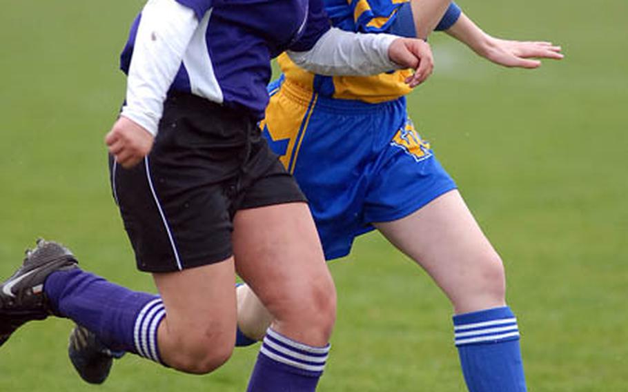 Manhheim&#39;s Jennifer Amos, left, and Wiesbaden&#39;s Emma Curtsinger fight for the ball in DODDS-Europe action on Saturday. Mannheim beat Wiesbaden 3-0.