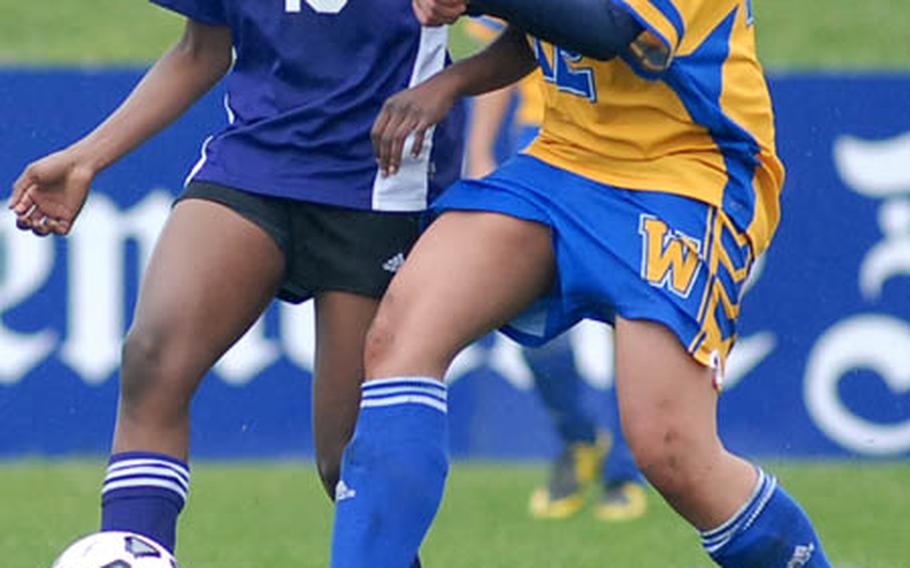 Mannheim&#39;s Alanna Crockwell, left, passes off to a teammate in front of Wiesbaden&#39;s Danielle Lewis in DODDS-Europe soccer action on Saturday.