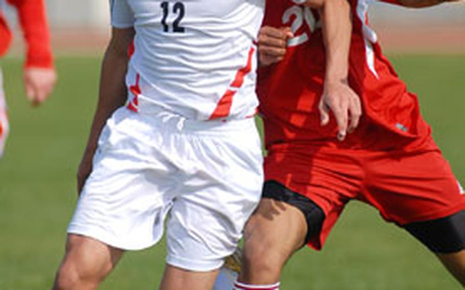 Heidelberg’s Blake Langford, left, and Kaiserslautern’s Leroy Porter fight for the ball during Heidelberg’s 8-0 victory on Saturday. Langford scored two goals in the contest, which ended at halftime.