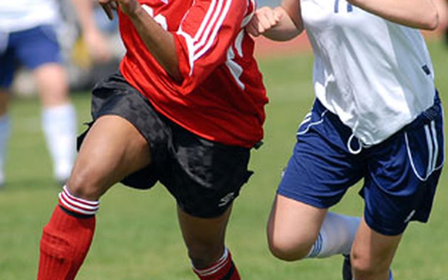 Kaiserslautern’s Liana Knight, left, looks for an open teammate after getting past Heidelberg’s Kristine Bremer in girls high school soccer action on Saturday. The close-fought game ended 0-0.