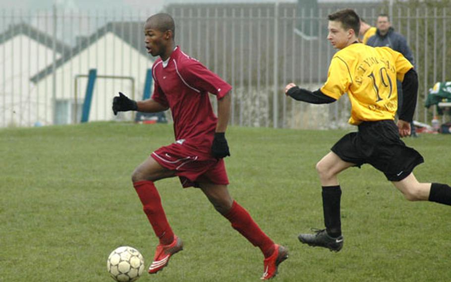 Alassane Doukoure races past Alconbury’s Ernestas Tyminas during Baumholder’s 4-1 victory on April 19. Doukoure scored two goals in the game. Doukoure emigrated to Baumholder last year from Ivory Coast.