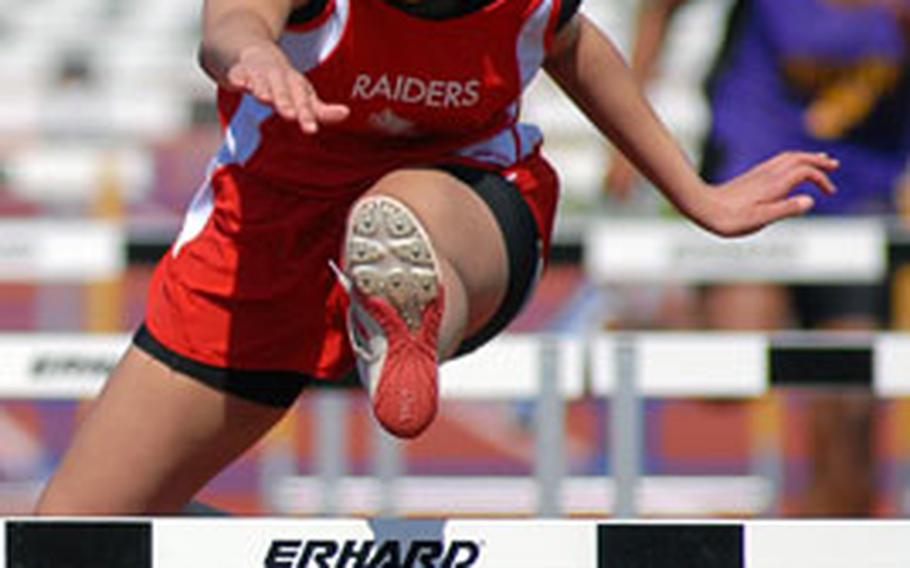 Kaiserslautern&#39;s Shalisa Baldwin clears a hurdle on her way to winning the 100-meter hurdles at the high school track meet in Mannheim, Germany, on Saturday. She finished in 17.32 seconds. Her brother Josiah took the boys 110-meter hurdles event.