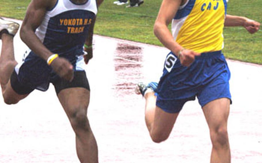 Yokota&#39;s Derrick Seward, left, and SungJun Son of the Christian Academy In Japan battle each other to the finish line in the 200 meters Saturday at the Kanto Plain Association of Secondary Schools track and field championship on Yokota Air Base, Japan. Miguel Rodriguez of Zama American won the event in 23.08.