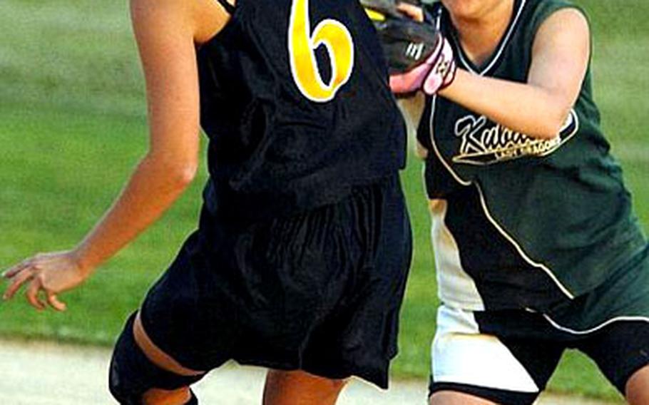 Kubasaki Dragons shortstop Veronica Johnston, right, readies a tag for Kadena Panthers baserunner Jennifer Jones during Wednesday&#39;s Game 1 of the 2008 Okinawa Activities Council district girls softball championship best-of-three series.