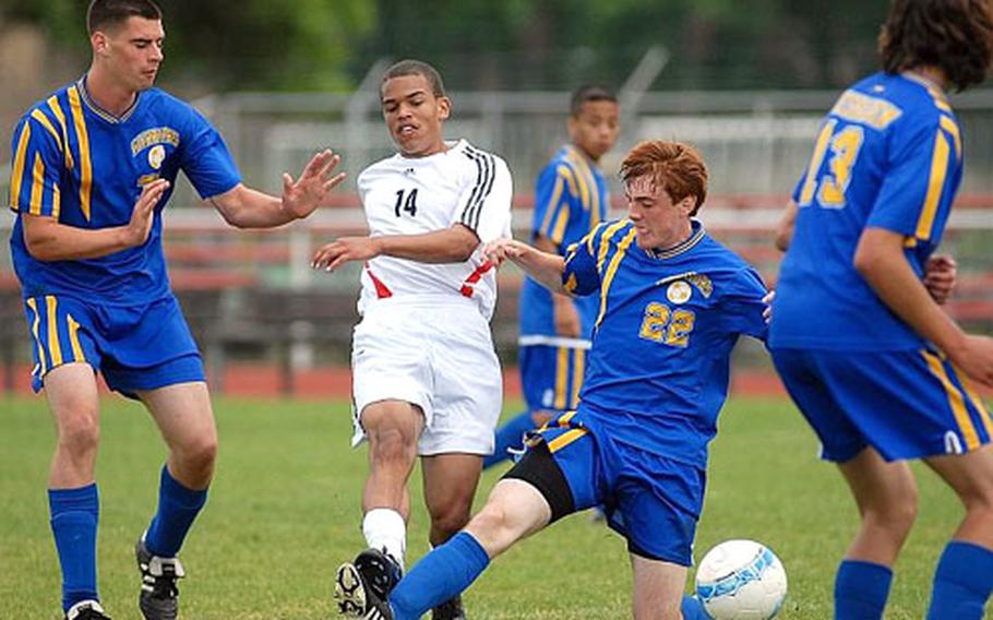 Heidelberg&#39;s Marvin Washington shoots on goal among a trio of Wiesbaden defenders, Isiah Hickman, left, Alan Gray, center, and Patrick Barrenechea.