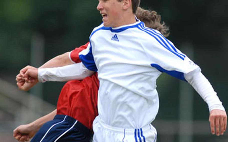 Ramstein&#39;s Tyler Curry, right, wins the air battle over ISB&#39;s Alex Siwek in a Division I game at the DODDS-Europe soccer finals. Ramstein won 3-0.