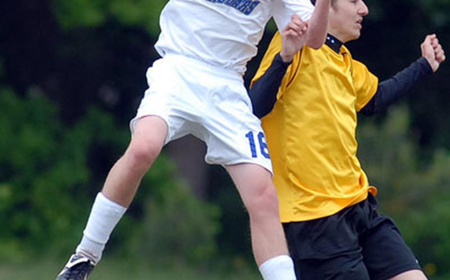 Sigonella&#39;s Sam Corey, left, heads the ball away from Alconbury&#39;s Matt Tropoulos.