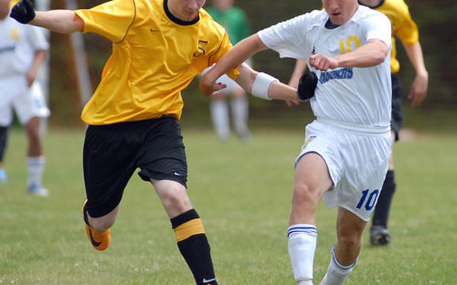 Alconbury&#39;s Joe Bass, left, and Sigonella&#39;s Dave Rice fight for the ball in their opening day match at the DODDS-Europe soccer championships in Kaiserslautern on Wednesday. Alconbury won, 1-0.