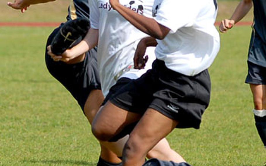 Bodies collide as Heidelberg&#39;s Ashleigh Mitchum, left, clears the ball in front of Jennifer Marten and Peo Fay Molelekeng of International School of Brussels and Heidelberg&#39;s Lauren Brousseau (on the ground) during ISB&#39;s 2-0 victory in the DODDS-Europe girls Division I soccer championship.