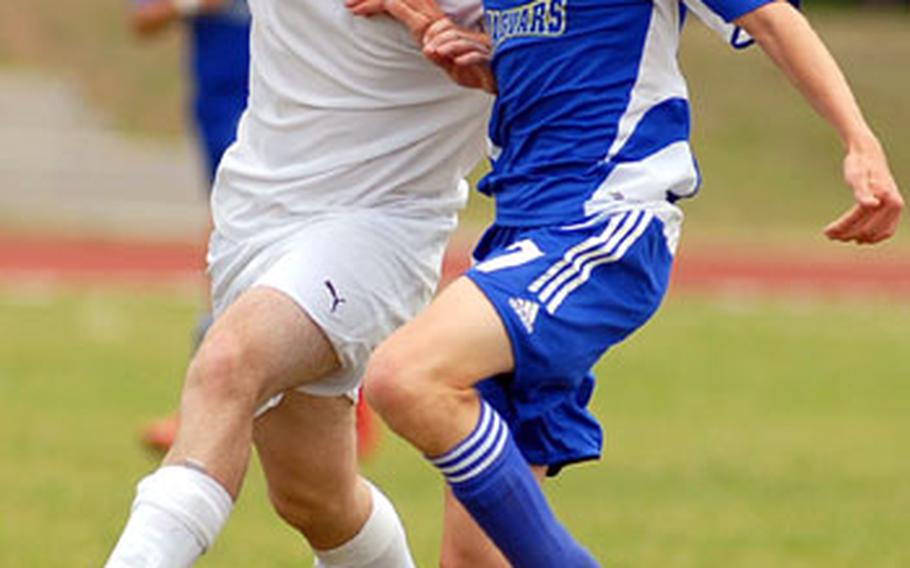 Rota&#39;s Alan Dowden, left, and Sigonella&#39;s Stewart Roberts fight for a ball during the DODDS-Europe boys Division IV soccer championship game that Rota won 1-0 in overtime.