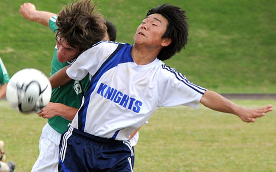 Kubasaki High School&#39;s Eddie Balfour (9) and Christian Academy in Japan&#39;s Lee Isoo fight for control of the ball.