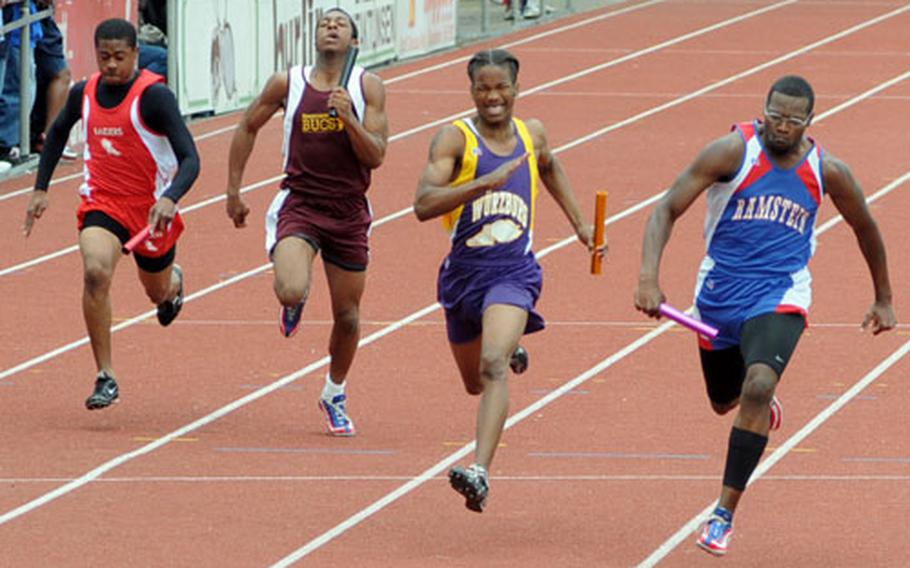Ramstein&#39;s John Lowder, right, anchor man on the 4x100 meter relay team, crosses the finish line in 44.29 for first place.