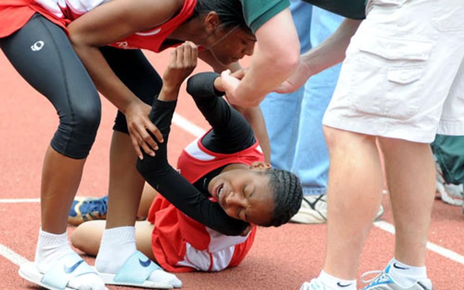 Aviano&#39;s Shelby Yoakum is assisted after she collapsed after winning the 1,500.