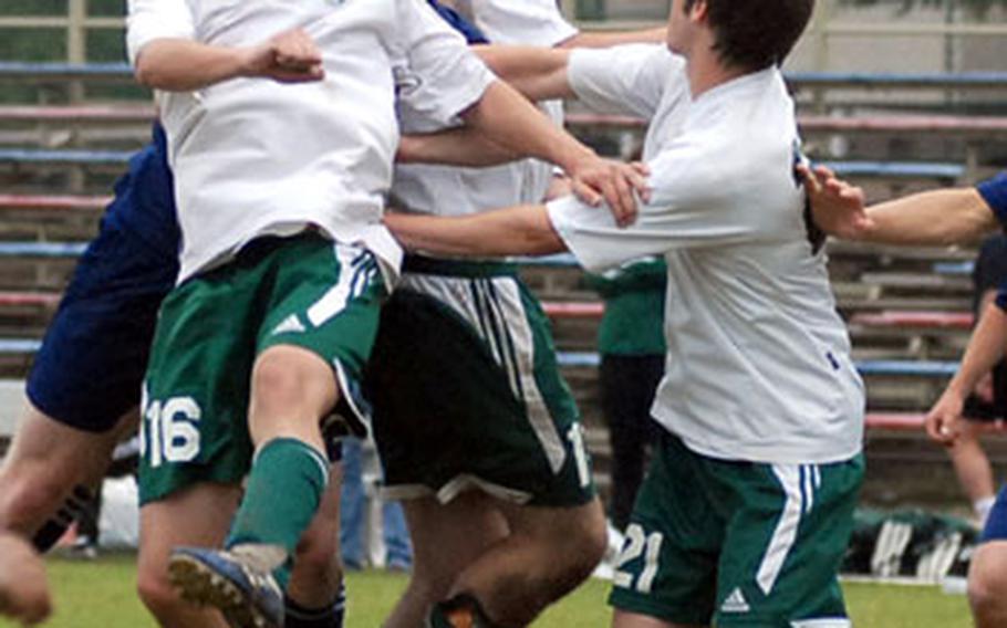 Black Forest Academy&#39;s Josiah Hanchett gets his head on the ball despite the defense of SHAPE&#39;s Piotr Kwiecien, Michael Clampitt and Daniele Coccia, and his ownn teammate Bruce Briggs. Hanchett later scored the 3-2 winning goal in overtime.