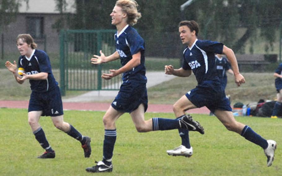 Black Forest Academy&#39;s Josiah Hanchett celebrates his game winning goal with teammates Bruce Briggs, left, and Judson Godbold, right.